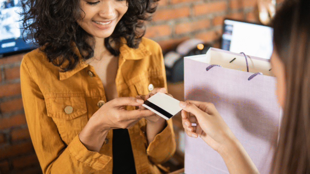 Person handing over a credit card.